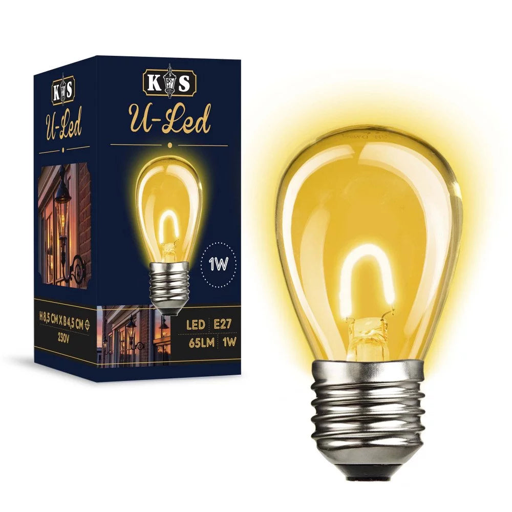Eingeschaltete E27 LED-Lampe in S14 Birnenform mit warmem Lichtschein neben dunkelblauer Produktverpackung