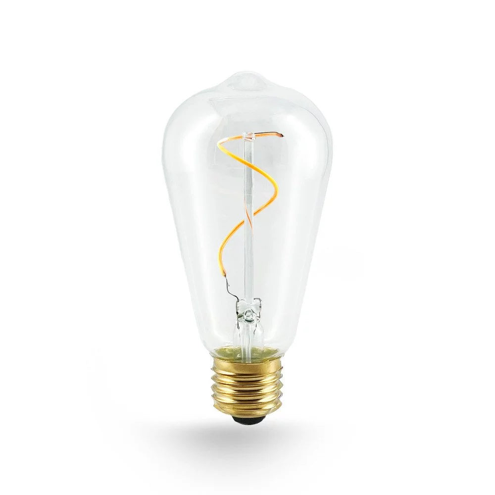 Freigestelltes E27 LED-Leuchtmittel in ST64 Edison-Form mit Klarglas, geschwungenem Spiral-Filament und Messingsockel, unbeleuchtet